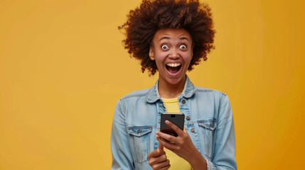 A person reacts with excitement while looking at their smartphone, fist clenched in triumph. - obrazy, fototapety, plakaty