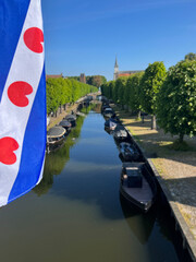 Frisian flag at the canal in Sloten - obrazy, fototapety, plakaty