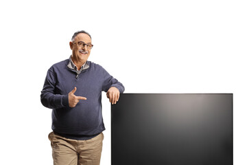 Mature man pointing a tv flat hd screen