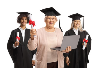 Graduation students and a mature woman with a laptop computer isolated on white background