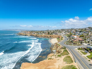 Aerial panorama of Sunset Beach in San Diego with ragged California ocean coastline, crushing...