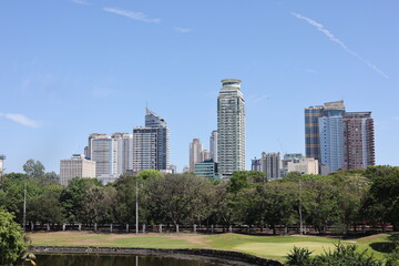 Fototapeta premium Buildings in manila near park in the day on March 30, 2024