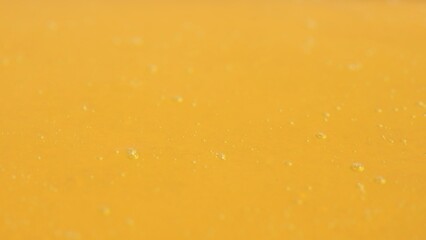 Healthy organic honey. Sweet fresh golden honey on the yellow background, close up shot of thick...