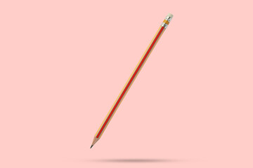 Orange pencil isolated on pink background close up