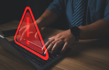 Hacker or programmer using laptop with triangle caution warning sign, coding, cryptography, hacker,...