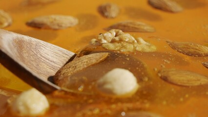 Healthy organic honey. Sweet fresh golden honey on the yellow background, wooden spoon scooping...