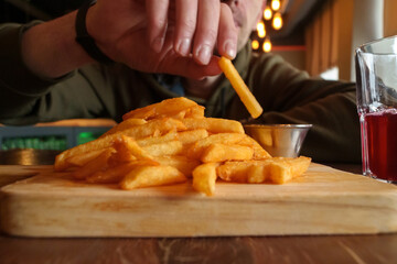 Close-Up of French Fries on Cutting Board, selective focus