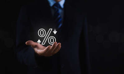 Businessman holding percentage sign in hand showing discount interest rate for commercial investment. To calculate business tax rates on a gray background.	