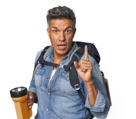 Hispanic trekker with backpack and flashlight having an idea, inspiration concept.