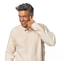 Middle-aged Latino man showing a mobile phone call gesture with fingers.