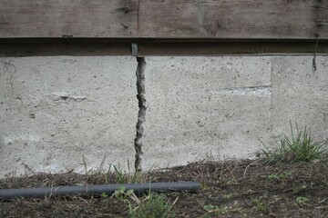 Close-up of a deep residential house foundation crack.