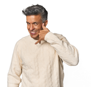 Middle-aged Latino man showing a mobile phone call gesture with fingers.