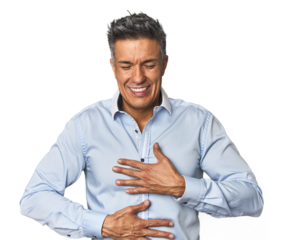 Middle-aged Latino man laughs happily and has fun keeping hands on stomach.