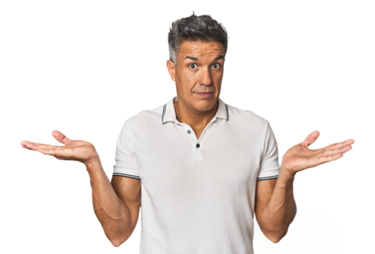 Middle-aged Latino man confused and doubtful shrugging shoulders to hold a copy space.