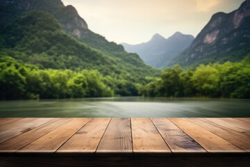 The empty wooden brown table top with blur background of river and mountain. Exuberant image....