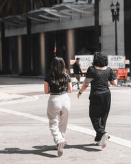 two women walking street downtown miami 