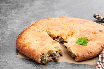 Kubdari with beef georgian flat pie on gray background