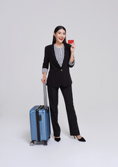 Elegant Business Woman with Travel Trolley Luggage. Female executive with suitcase in work related business trip showing credit card