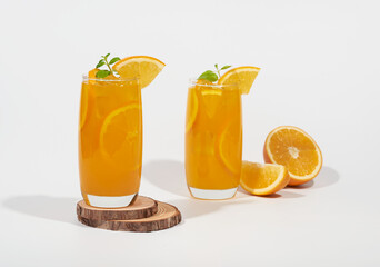 Squeezed orange juice garnished with orange slice isolated on white background.