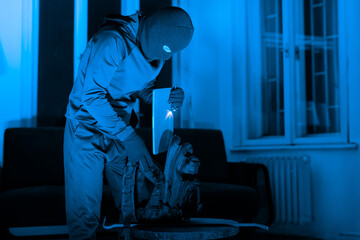 Masked man criminal preparing tools for burglary - obrazy, fototapety, plakaty