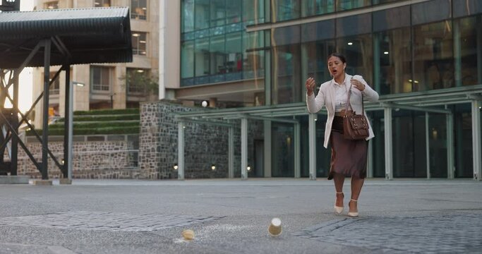 Business woman, street and spill coffee with mistake, walking and anger with trip, schedule and outdoor in city. Person, employee and stress with mess for drink on metro sidewalk by office building