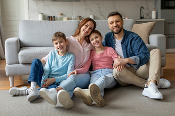 Happy family sitting on the living room sofa
