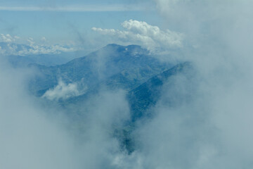 Bright panorama of the cloudy Andes Mountains from the Cerro las Nubes, Mount of the Clouds, in Jerico, Jericó, Antioquia, Colombia. Blue sky whith clouds and mist.