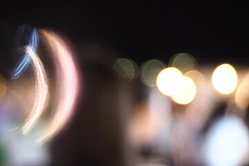 Bokeh, bright shining lights of the district in the nighttime on blurred background.