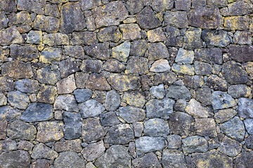 Parede de pedras vulcânicas de basalto, imagem de fundo natural formada por rochas. 