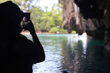 Tourist takes picture from inside Underground Cave in Palawan on April 4, 2024
