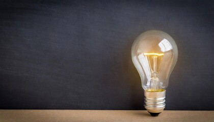 light bulb lamp on blackboard background with copy space 