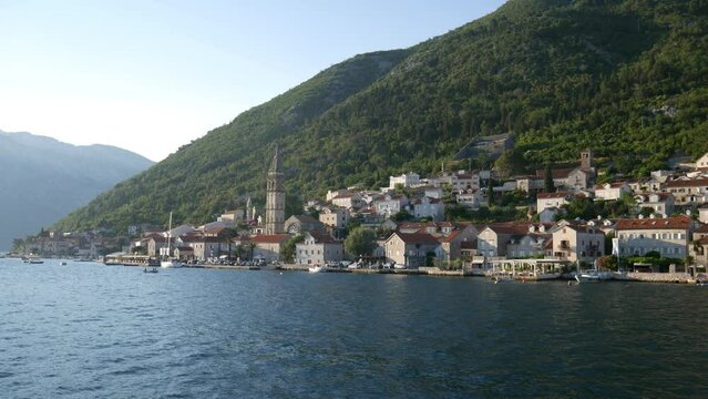 View of old town of Perast in the Bay of Kotor on Adriatic sea in Montenegro. Shooting video from a moving boat.
