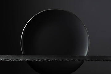 Black stone podium and black circle ceramic plate for luxury product placement.