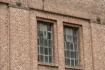 Details of an old industrial building, brick wall and windows, approx. 100 years old