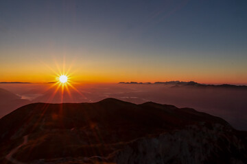 Scenic sunrise view from summit Dobratsch on Julian Alps and Karawanks in Austria, Europe....