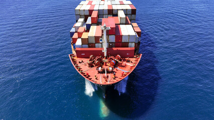 Aerial drone photo of huge fully loaded container tanker ship carrying truck size colourful...
