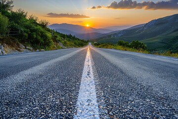 Low level view of paved road in the mountains. - obrazy, fototapety, plakaty
