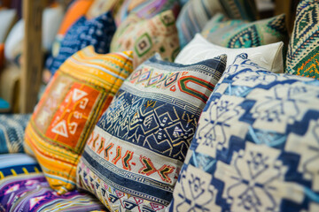 Fototapeta na wymiar A collection of colorful pillows with various patterns and designs