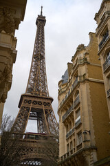 Fototapeta na wymiar Eiffel Tower in Paris seen from side streets