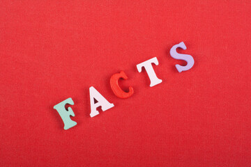 FACTS word on red background composed from colorful abc alphabet block wooden letters, copy space...