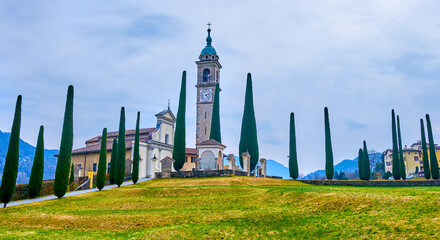 Panorama of St Abundius (Sant'Abbondio) Church and cypress trees, Collina d'Oro, Ticino, Switzerland