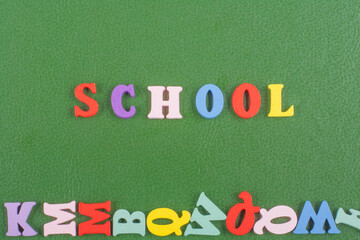 SCHOOL word on green background composed from colorful abc alphabet block wooden letters, copy space for ad text. Learning english concept.