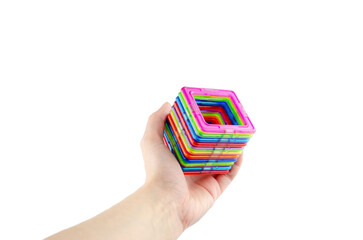 A group of colorful transparent magnet squares (puzzle game for kids) connected into a tunnel in a...
