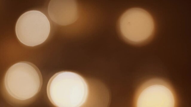 Rich brown and golden bokeh background, perfect for adding warmth and depth to your designs.