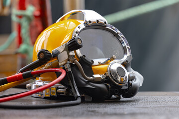 Yellow Commercial diving helmet on the ground closeup