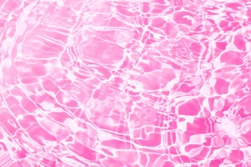 Transparent pink clear water surface texture with ripples, splash and bubbles. Clean water with reflection of sun. water ripple surface on pink background. Minimal summer concept