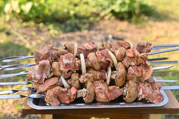 raw meat on barbecue skewers.