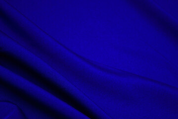 Blue fabric closeup. Plexus threads. Clothing industry. Abstract background. Textile waves.