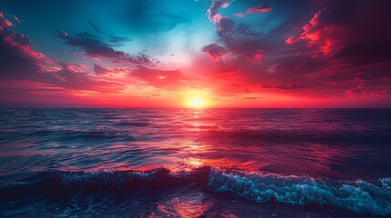   The sun sets over the ocean, painting the sky red and blue A solitary wave breaks in the foreground