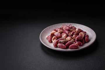 Raw chicken hearts with salt, spices and herbs
